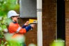 Airsafe consultant checking a painted verandah post for lead with an XRF analyser