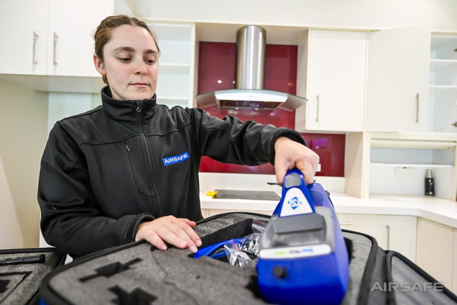 Airsafe consultant unpacking a DustTrak DRX dust monitor from its case