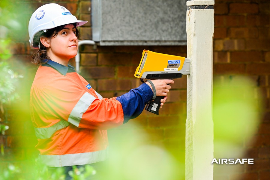 Airsafe consultant testing painted surfaces for lead with an XRF analyser