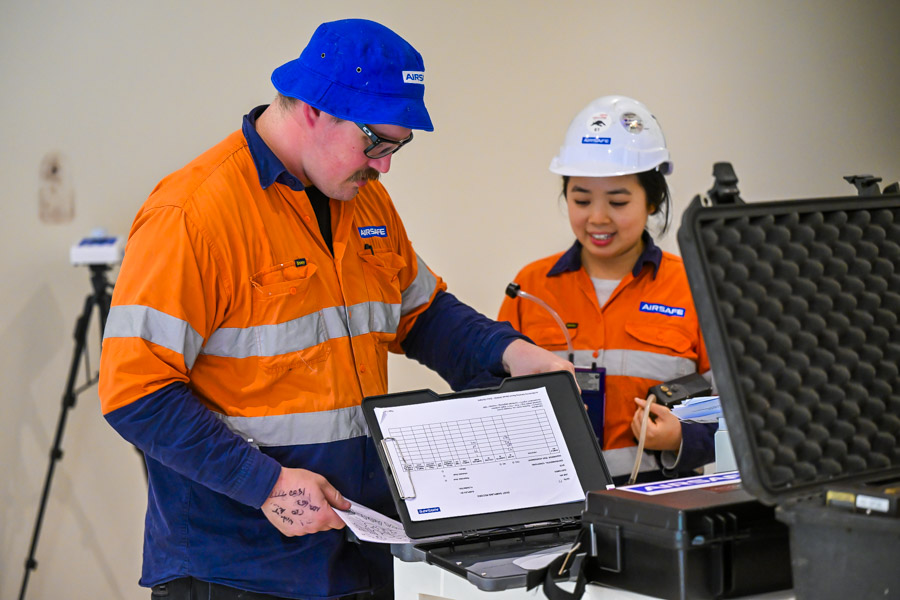 Two Airsafe consultants reviewing air sampling results during a mould investigation