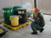 Inspector checking hazardous waste barrels
