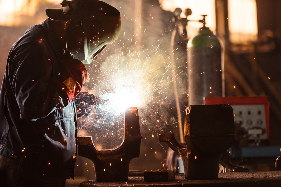 Industrial Worker at the factory welding closeup