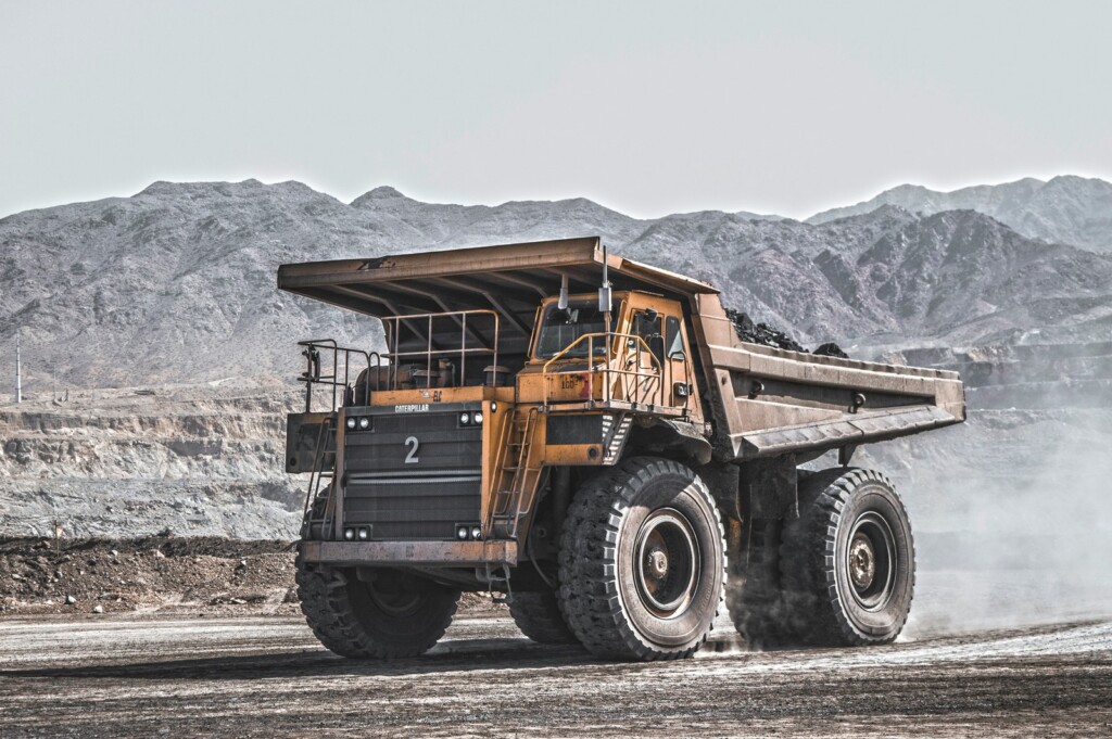 Diesel haul truck raising dust at an open-cut mine