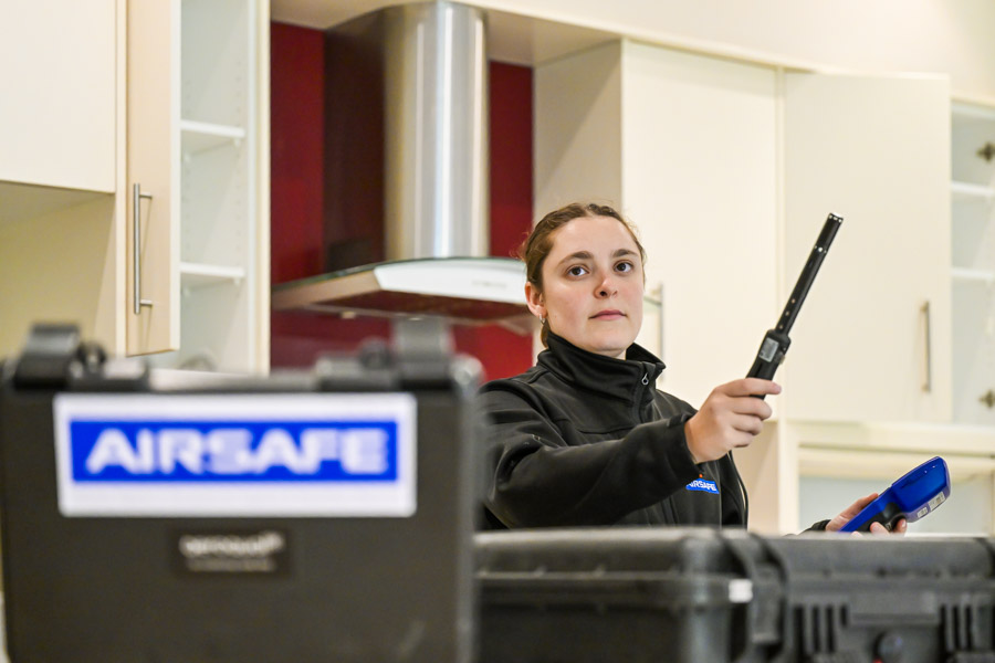 Airsafe consultant measuring volatile organic compounds with a handheld Aeroqual monitor