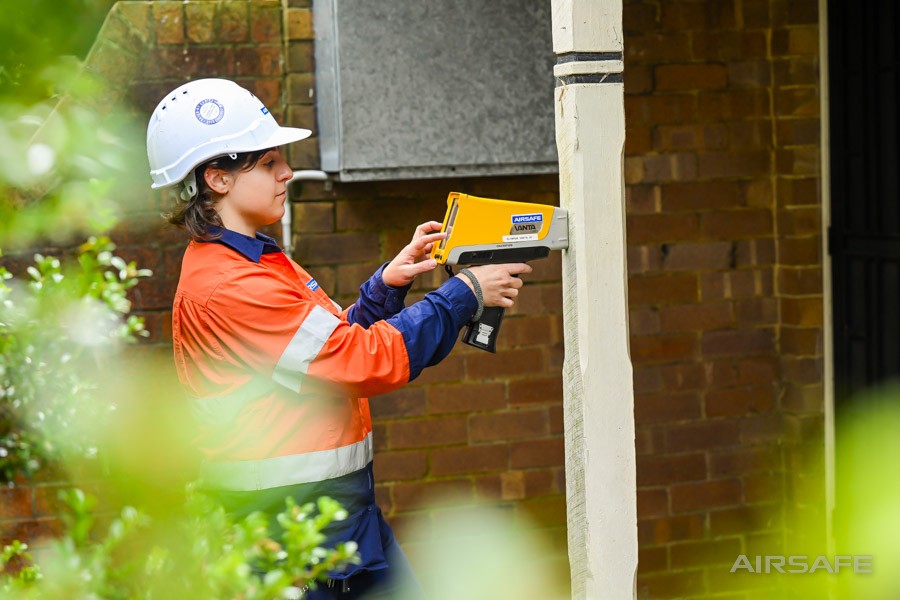 Airsafe consultant testing painted surfaces for lead with a handheld XRF analyser