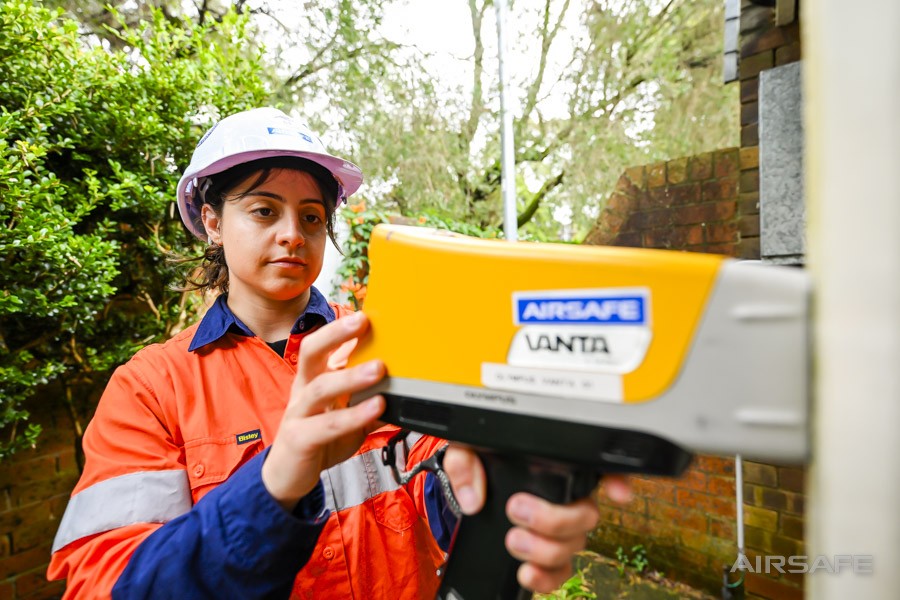 Airsafe consultant checking results on an Olympus Vanta XRF analyser during lead paint testing