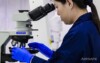 An Airsafe analyst working at a microscope in the Beaconsfield laboratory