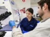 Two Airsafe analysts examining a sample together in the Beaconsfield laboratory