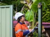 An Airsafe occupational hygienist setting up a static air monitor at a residential site