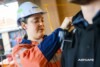 Airsafe consultant fitting a personal air sampling head to a worker's collar before monitoring starts