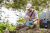 Airsafe consultant collecting a soil sample into a jar during a site investigation